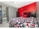 Vibrant bedroom featuring a bold red accent wall, dark furniture, and natural light at 704 Willow Rd, Salisbury, NC 28147