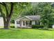 View of home with covered front porch and well maintained yard, surrounded by lush greenery at 704 Willow Rd, Salisbury, NC 28147