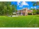 Expansive backyard featuring pool, screened porch and lush greenery at 7229 Olde Sycamore Dr, Mint Hill, NC 28227