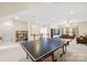 Large basement with ping pong table, a bookcase, and a comfortable seating area with plenty of room to roam at 7229 Olde Sycamore Dr, Mint Hill, NC 28227