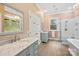 A bathroom with dual sinks, a glass enclosed shower, and natural light from the window at 7229 Olde Sycamore Dr, Mint Hill, NC 28227