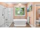 Serene bathroom with a soaking tub, walk-in shower, and modern fixtures at 7229 Olde Sycamore Dr, Mint Hill, NC 28227