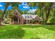 Charming brick home with manicured lawn and mature trees, offering classic curb appeal at 7229 Olde Sycamore Dr, Mint Hill, NC 28227