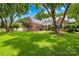 Charming brick home with manicured lawn, mature trees, and a welcoming front porch at 7229 Olde Sycamore Dr, Mint Hill, NC 28227