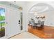 Foyer leading to a dining room with elegant chandelier, hardwood floors, and decorative wall panels at 7229 Olde Sycamore Dr, Mint Hill, NC 28227