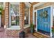 Welcoming front entrance with blue door, brick accents, and well-manicured landscaping at 7229 Olde Sycamore Dr, Mint Hill, NC 28227