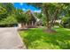 Beautifully landscaped front yard with mature trees surrounding this brick home at 7229 Olde Sycamore Dr, Mint Hill, NC 28227