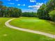 Scenic view of a well-maintained golf course on a sunny day, perfect for golf enthusiasts at 7229 Olde Sycamore Dr, Mint Hill, NC 28227