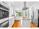 Modern kitchen with stainless steel appliances, white cabinets, and center island at 7229 Olde Sycamore Dr, Mint Hill, NC 28227