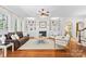 Bright living room with fireplace, built-in bookshelves, hardwood flooring, and modern furniture at 7229 Olde Sycamore Dr, Mint Hill, NC 28227