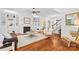 Cozy living room featuring hardwood floors, fireplace, built-in shelving, and stylish seating at 7229 Olde Sycamore Dr, Mint Hill, NC 28227