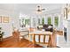 Living room with hardwood floors, fireplace, and large windows offering views of the outdoors at 7229 Olde Sycamore Dr, Mint Hill, NC 28227