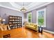 Bright living room with piano, hardwood floors, yellow sofa, and natural light streaming through windows at 7229 Olde Sycamore Dr, Mint Hill, NC 28227