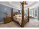 Spacious main bedroom with decorative columns, tray ceiling, and a bay window at 7229 Olde Sycamore Dr, Mint Hill, NC 28227