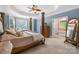 Luxurious main bedroom suite with decorative columns, tray ceilings, and ample natural light at 7229 Olde Sycamore Dr, Mint Hill, NC 28227