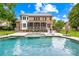 Picturesque backyard featuring a sparkling pool, patio with chairs, and a well-maintained lawn at 7229 Olde Sycamore Dr, Mint Hill, NC 28227