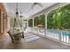 Relaxing covered porch with swing, offering views of the pool and backyard oasis at 7229 Olde Sycamore Dr, Mint Hill, NC 28227