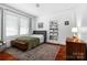Sunlit bedroom featuring hardwood floors, built-in shelves, a bed and an antique chest at 772 Eden Ter, Rock Hill, SC 29730