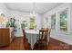 Bright dining room featuring hardwood floors, a chandelier, and multiple windows for natural light at 772 Eden Ter, Rock Hill, SC 29730