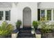 Close-up of the front door with plants on the stoop, showcasing the house number and white brick facade at 772 Eden Ter, Rock Hill, SC 29730