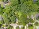 Aerial view of the property showcasing the lot surrounded by lush trees, homes, and nearby roads at 822 Cantwell St, Charlotte, NC 28208