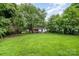 Lush backyard with mature trees surrounding the space providing a private outdoor area at 822 Cantwell St, Charlotte, NC 28208