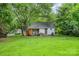 Expansive backyard with lush green grass and mature trees, offering a private outdoor space at 822 Cantwell St, Charlotte, NC 28208