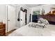 Bright bedroom featuring a wooden bed frame with plush toys, a closet, and a window at 822 Cantwell St, Charlotte, NC 28208