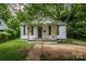 Charming single-story home with white siding and a welcoming front porch at 822 Cantwell St, Charlotte, NC 28208