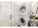 Compact laundry area with a stacked washer and dryer unit, plus storage space at 822 Cantwell St, Charlotte, NC 28208