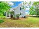 View of the home's backyard showing the siding, lawn, and patio with trees providing ample shade at 904 Venus St, Kannapolis, NC 28083
