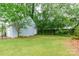 View of the home's backyard and detached garage with a privacy fence and ample green space at 904 Venus St, Kannapolis, NC 28083