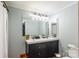 Bathroom with double sink vanity, white cabinets and modern lighting at 904 Venus St, Kannapolis, NC 28083