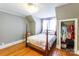 This bedroom features hardwood floors and a closet filled with clothes at 904 Venus St, Kannapolis, NC 28083