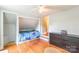 Cozy bedroom features a built-in bed, hardwood floors, and a ceiling fan at 904 Venus St, Kannapolis, NC 28083