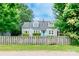 Two-story home framed by mature trees and a weathered wooden fence at 904 Venus St, Kannapolis, NC 28083