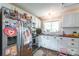 Cozy kitchen featuring brick floors, white cabinets and stainless steel refrigerator, oven, and microwave at 904 Venus St, Kannapolis, NC 28083