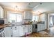 Charming kitchen with wood countertops, white cabinets and subway tile backsplash at 904 Venus St, Kannapolis, NC 28083