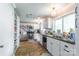 Well-lit kitchen with white cabinets, stainless steel appliances, and brick flooring at 904 Venus St, Kannapolis, NC 28083