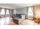 Cozy living room featuring hardwood floors, a comfortable sectional, and natural light from windows at 904 Venus St, Kannapolis, NC 28083