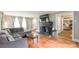 Open living room showcasing hardwood floors, black brick fireplace, and a sectional sofa at 904 Venus St, Kannapolis, NC 28083