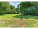 Spacious backyard with mature trees and well-manicured lawn at 9410 Mountain Aire Cir, Charlotte, NC 28214