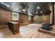 Finished basement with a rustic bar, wood-paneled walls, and a cozy wood-burning stove, perfect for entertaining at 9410 Mountain Aire Cir, Charlotte, NC 28214