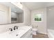 Bathroom featuring a vanity, undermount sink, modern fixtures, and subway tile in shower and backsplash at 9410 Mountain Aire Cir, Charlotte, NC 28214