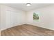 Cozy bedroom with a closet, window, and light wood-look flooring at 9410 Mountain Aire Cir, Charlotte, NC 28214