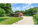 Sprawling home featuring a long driveway, attached garage, and a well-manicured lawn, perfect for outdoor enjoyment at 9410 Mountain Aire Cir, Charlotte, NC 28214