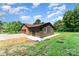 View of a two-car garage, wood-look siding, brick accent wall, and well-maintained lawn at 9410 Mountain Aire Cir, Charlotte, NC 28214