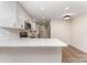 Bright, updated kitchen with white cabinets, quartz countertops, stainless appliances and modern light fixtures at 9410 Mountain Aire Cir, Charlotte, NC 28214