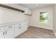 Functional laundry room featuring white cabinets, ample countertop space, and modern fixtures, enhancing convenience at 9410 Mountain Aire Cir, Charlotte, NC 28214
