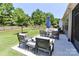 Large backyard with green grass, iron fence, and patio with seating area at 9541 Festival Way, Charlotte, NC 28215